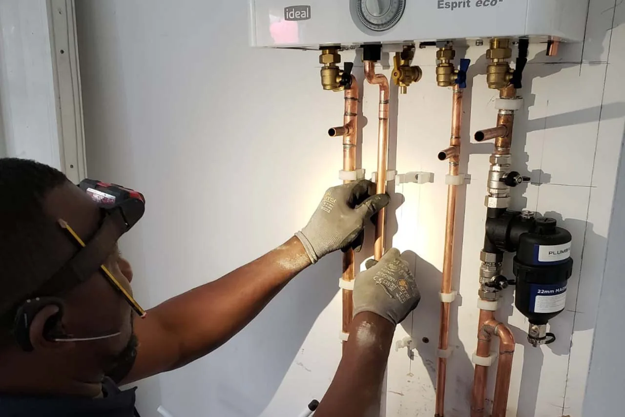Engineer working on boiler pipework